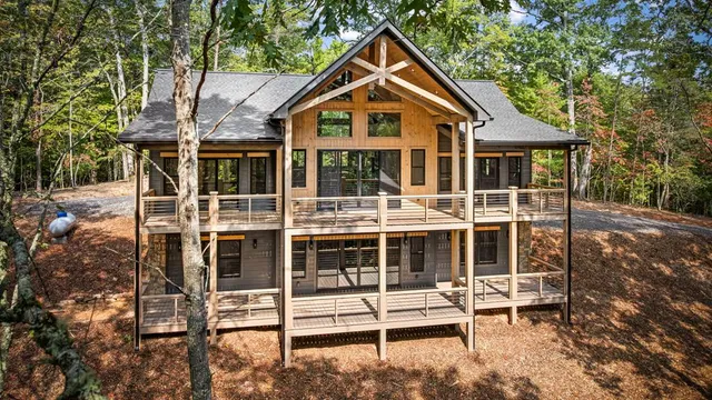 a front view of a house with a yard and balcony