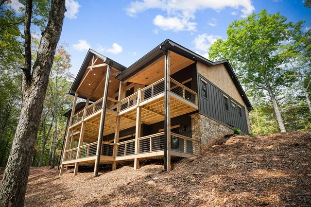 a view of balcony with wooden floor and iron fence