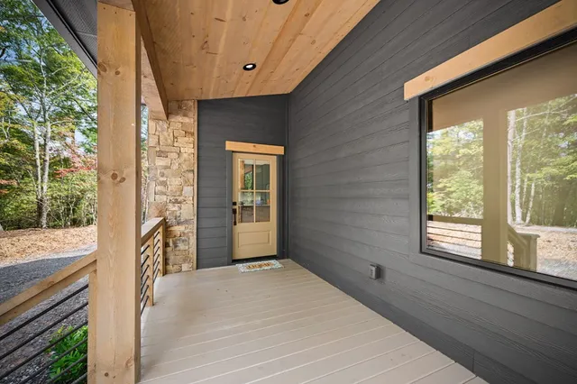 a view of a wooden deck with a yard