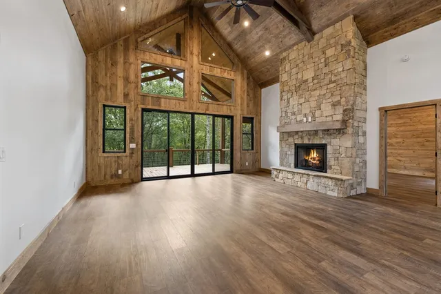 a view of an empty room with a fireplace and a window