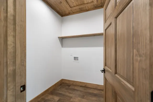 an empty room with wooden floor and natural light