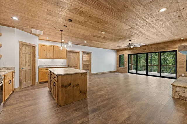 a kitchen with stainless steel appliances granite countertop a sink a stove and a refrigerator