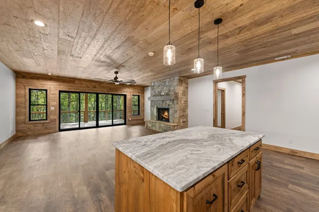 a living room with furniture fireplace and a large window