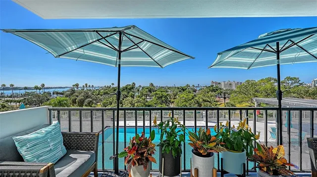 a view of a balcony with furniture and umbrella