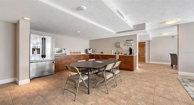 a view of a chairs and table in patio with a lake view