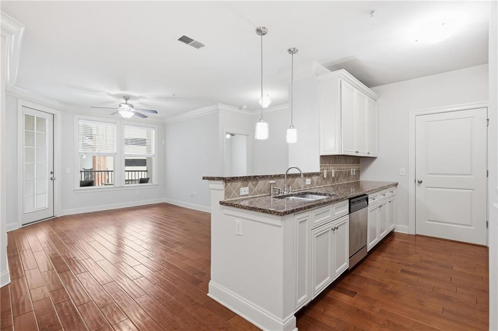 901 Abernathy Road Northeast, Unit 3080 Atlanta, GA 30328 - Photo 2 of 21 a large kitchen with a stove and wooden floor