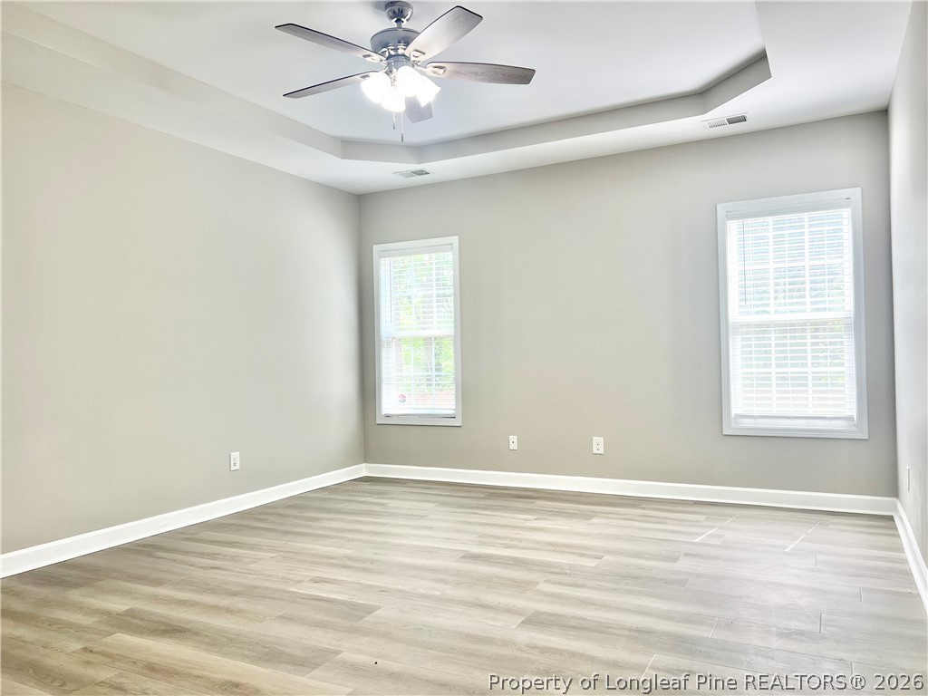 1523 Rough Rider Lane Parkton, NC 28371 - Photo 24 of 42 a view of an empty room with a window and wooden floor