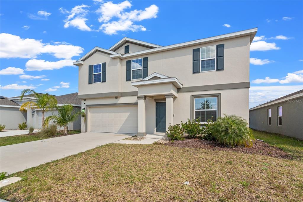 293 Pineywoods Street St. Cloud, FL 34772 - Photo 1 of 1 a front view of a house with garden