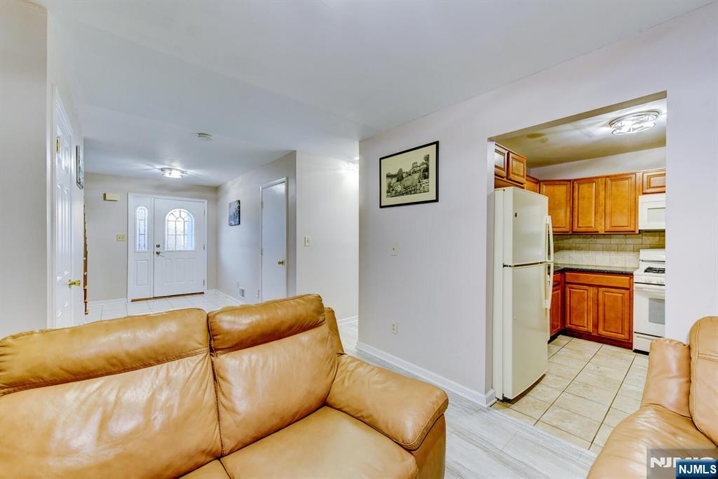 6 Hansen Place, Unit 6 Wayne, NJ 07470 - Photo 20 of 49 a living room with furniture and a wooden floor