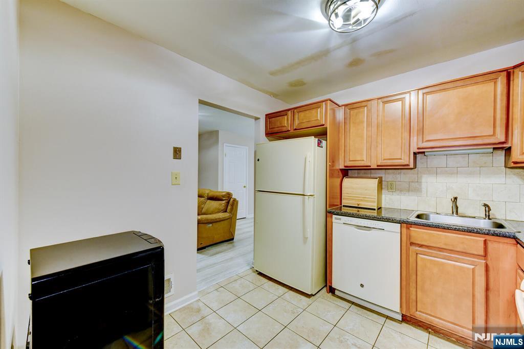 6 Hansen Place, Unit 6 Wayne, NJ 07470 - Photo 24 of 49 a kitchen with a refrigerator and a sink