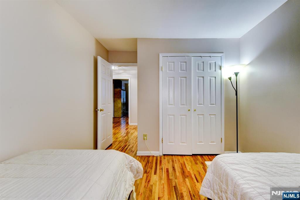 6 Hansen Place, Unit 6 Wayne, NJ 07470 - Photo 38 of 49 a bedroom with a bed and a mirror