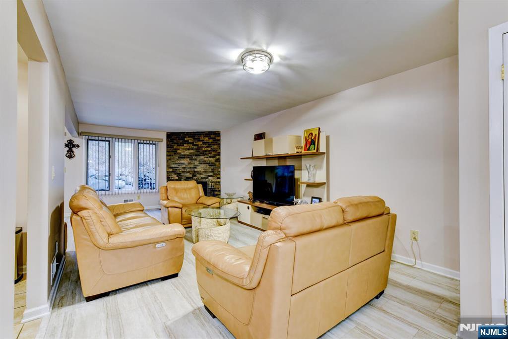6 Hansen Place, Unit 6 Wayne, NJ 07470 - Photo 6 of 49 a living room with furniture and a fireplace