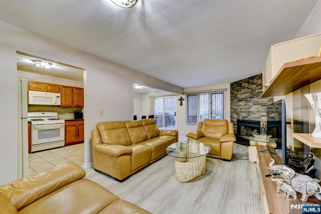 6 Hansen Place, Unit 6 Wayne, NJ 07470 - Photo 8 of 49 a living room with furniture and a kitchen view