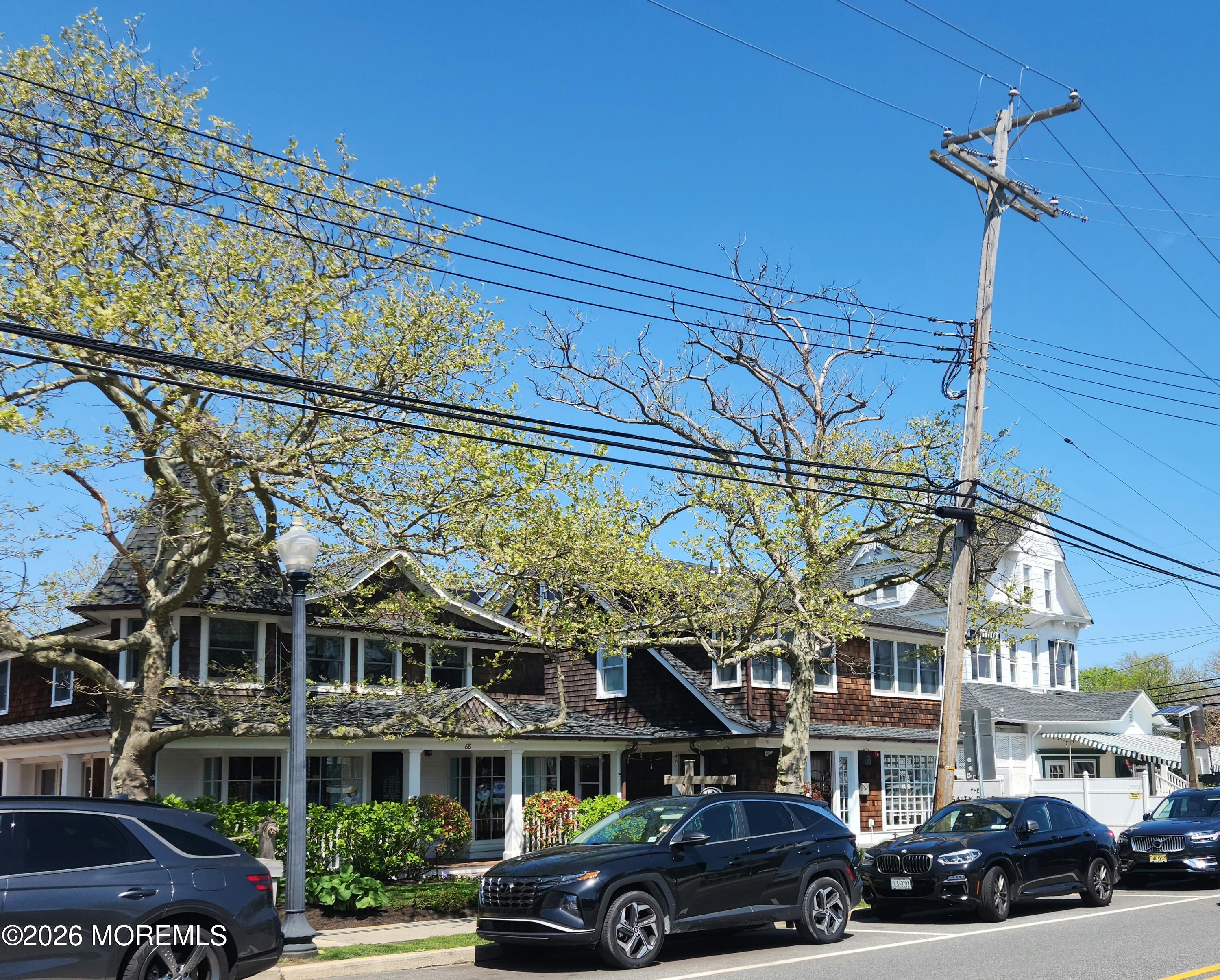 924 Ocean Road Point Pleasant, NJ 08742 - Photo 52 of 56 a front view of a building with lot of cars and trees