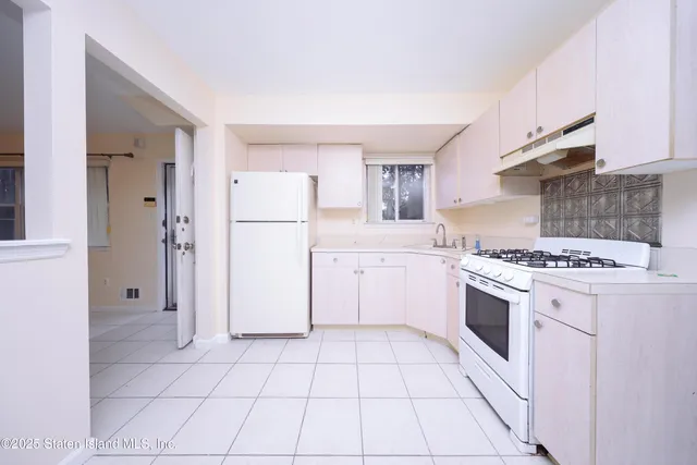 a kitchen with a stove a sink and a refrigerator