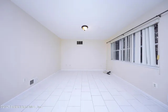 a view of an empty room with windows