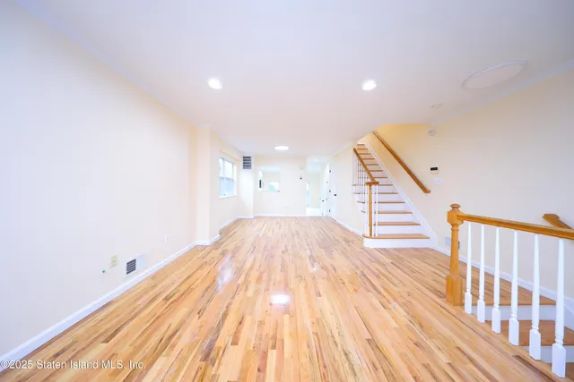 a view of a room with wooden floor and staircase