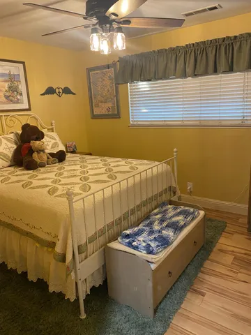 a bed sitting in a bedroom next to a window