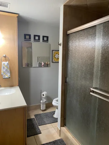 a bathroom with a toilet and a shower