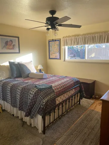 a bedroom with a bed and a chandelier