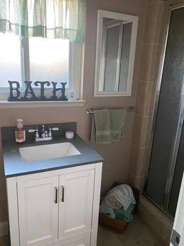 a bathroom with a sink and a window
