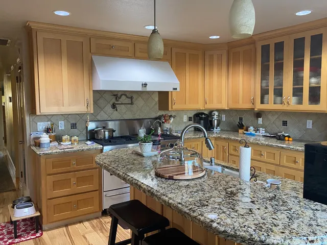 a kitchen with a stove a sink and a refrigerator