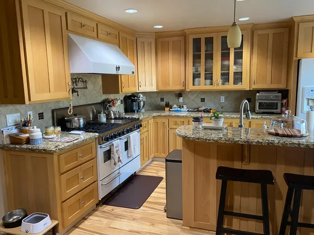 a kitchen with a sink stove and cabinets