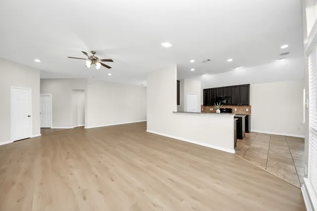 a view of kitchen with microwave and cabinets