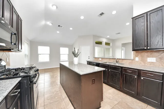 a kitchen with counter top space sink and stove