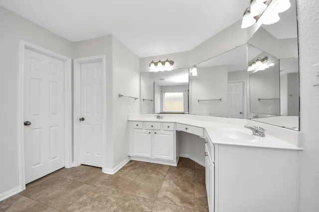 a bathroom with a sink a mirror and a shower