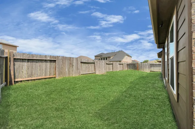 a view of a house with backyard and a garden