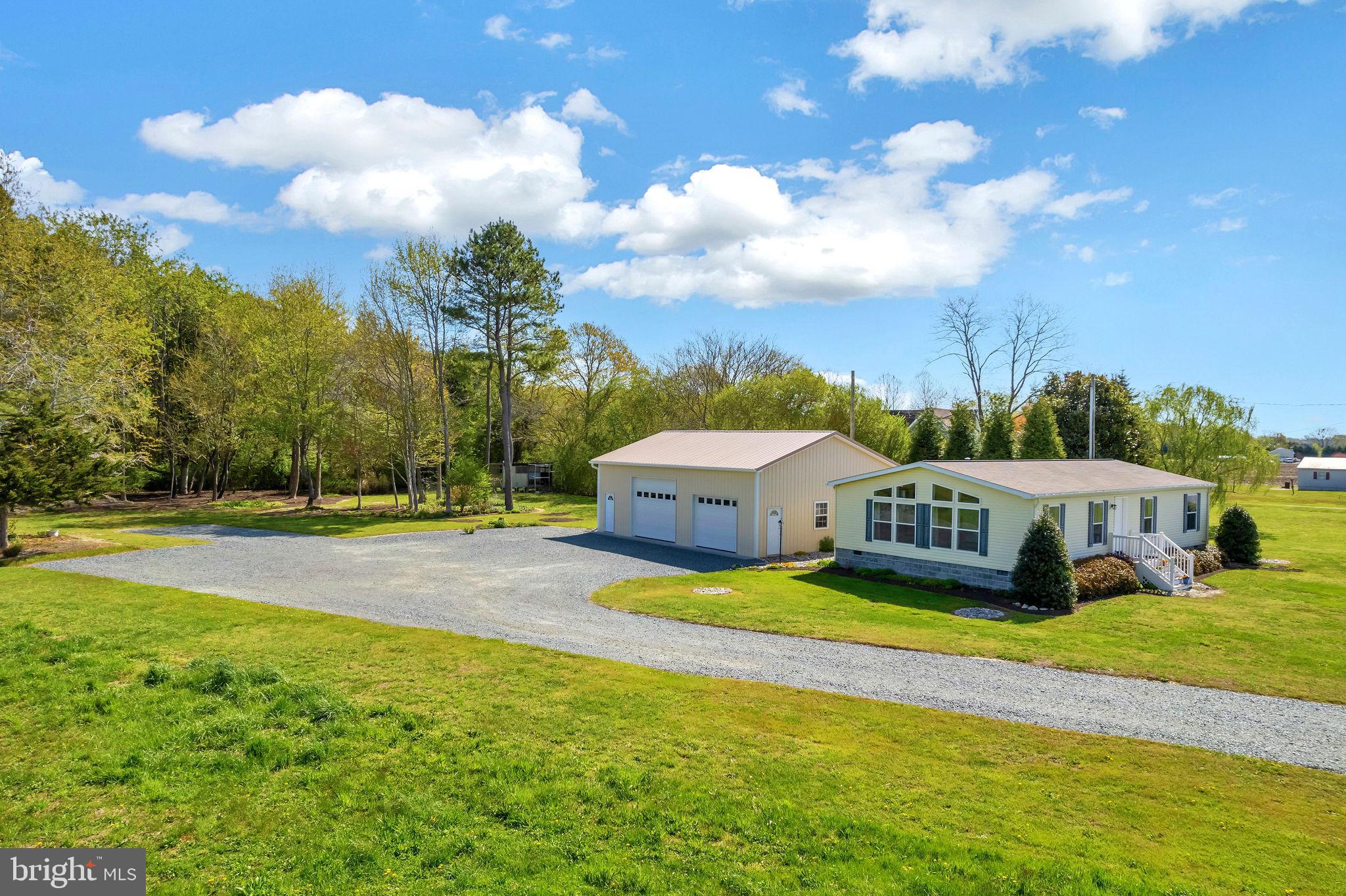 a view of a house with swimming pool and yard