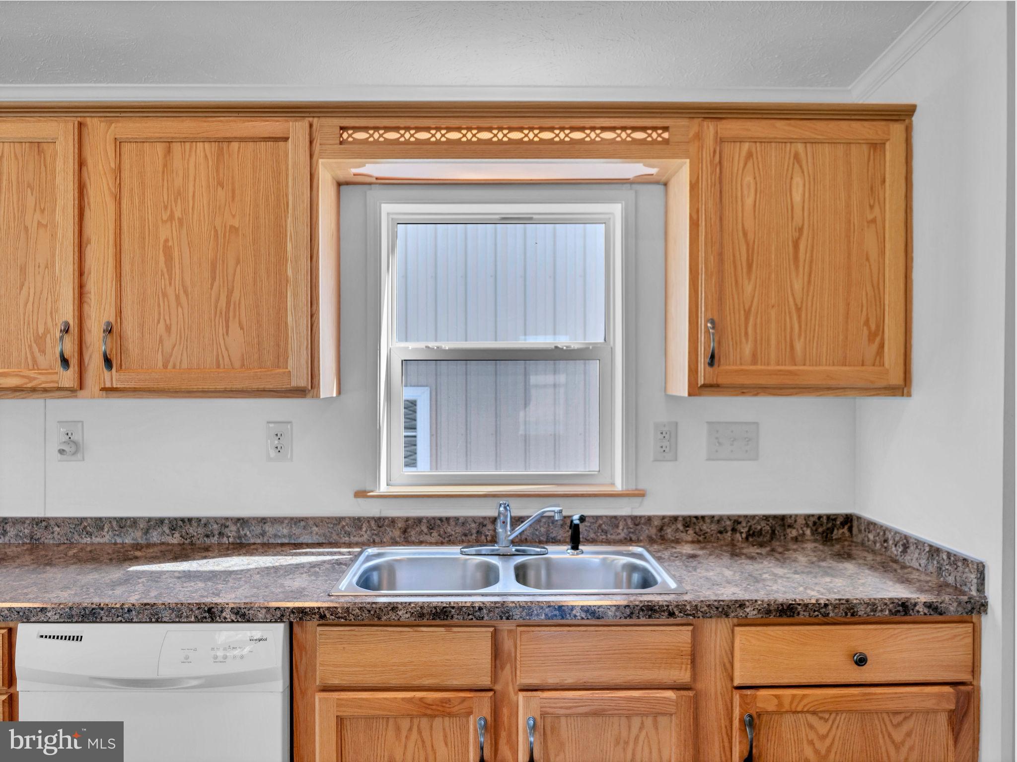 9811 Peerless Road Bishopville, MD 21813 - Photo 13 of 66 a kitchen with granite countertop a sink and a cabinets