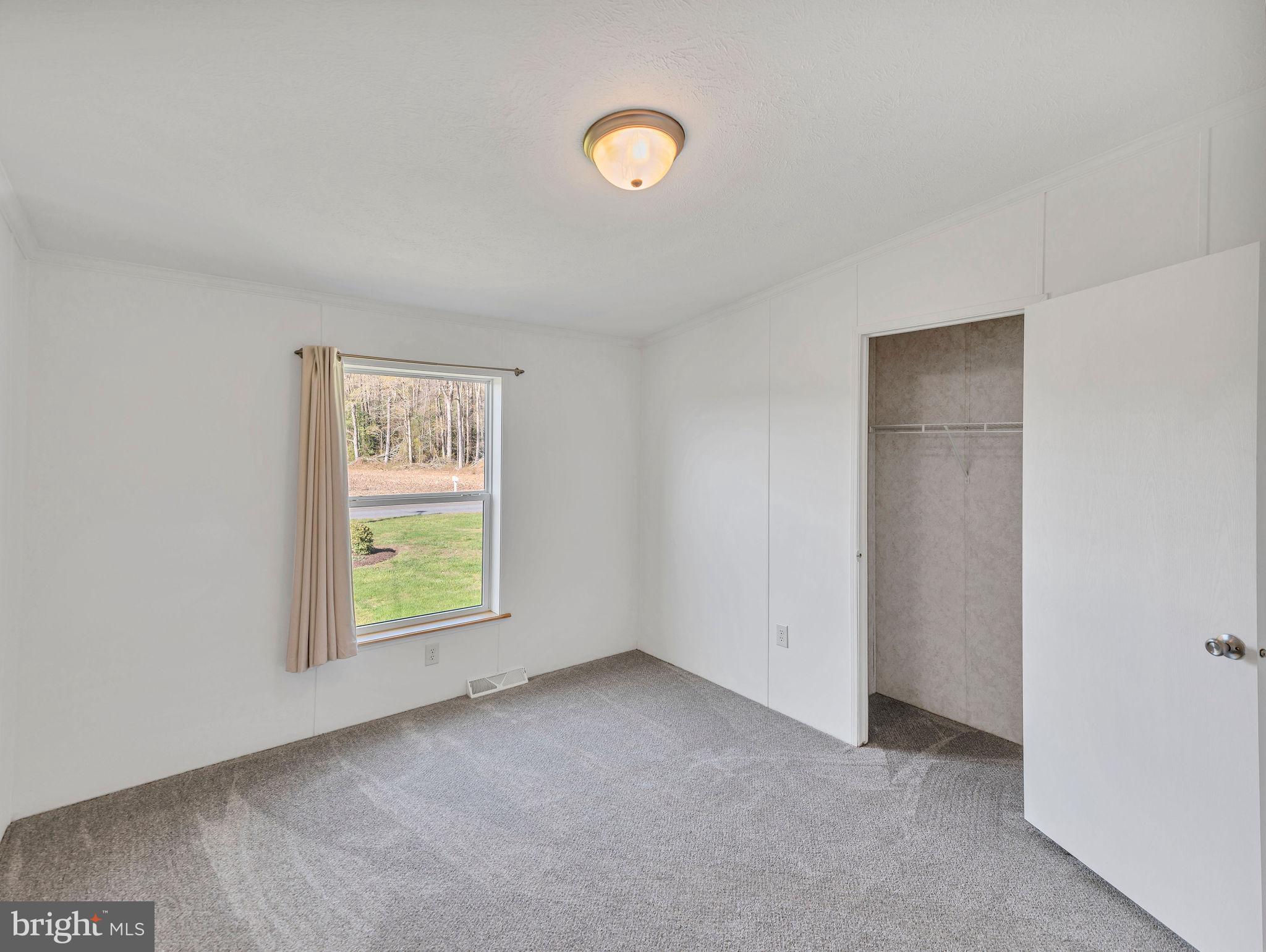 9811 Peerless Road Bishopville, MD 21813 - Photo 22 of 66 an empty room with windows and window