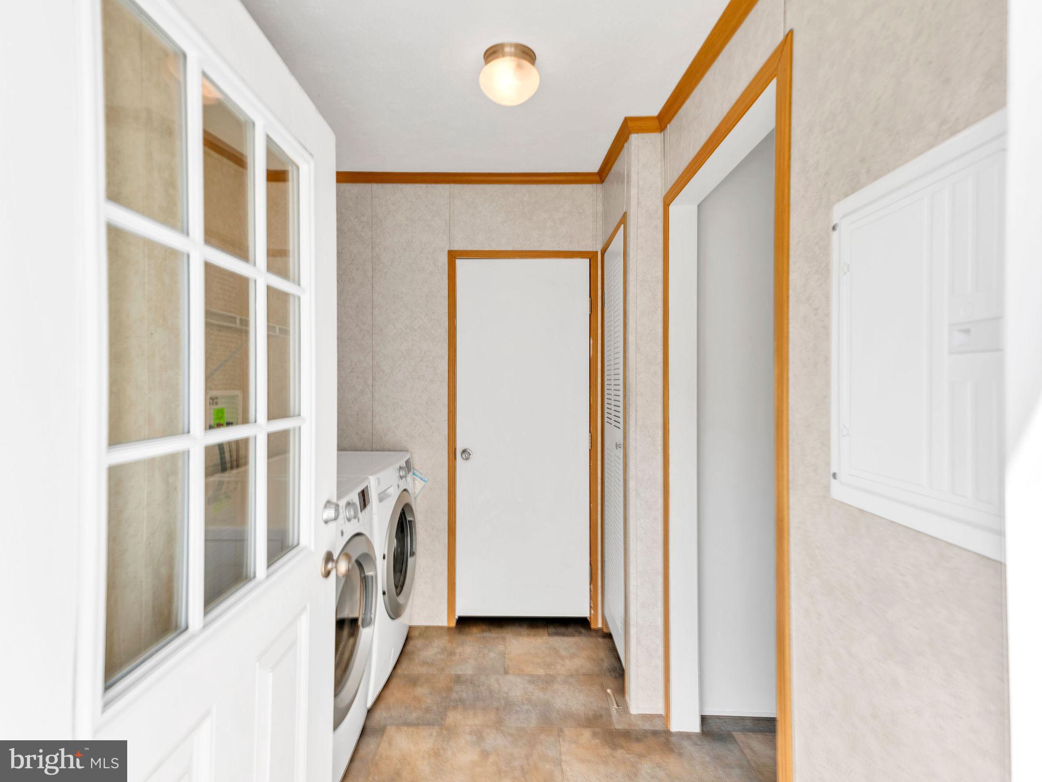 9811 Peerless Road Bishopville, MD 21813 - Photo 29 of 66 a view of a hallway with windows and cabinet