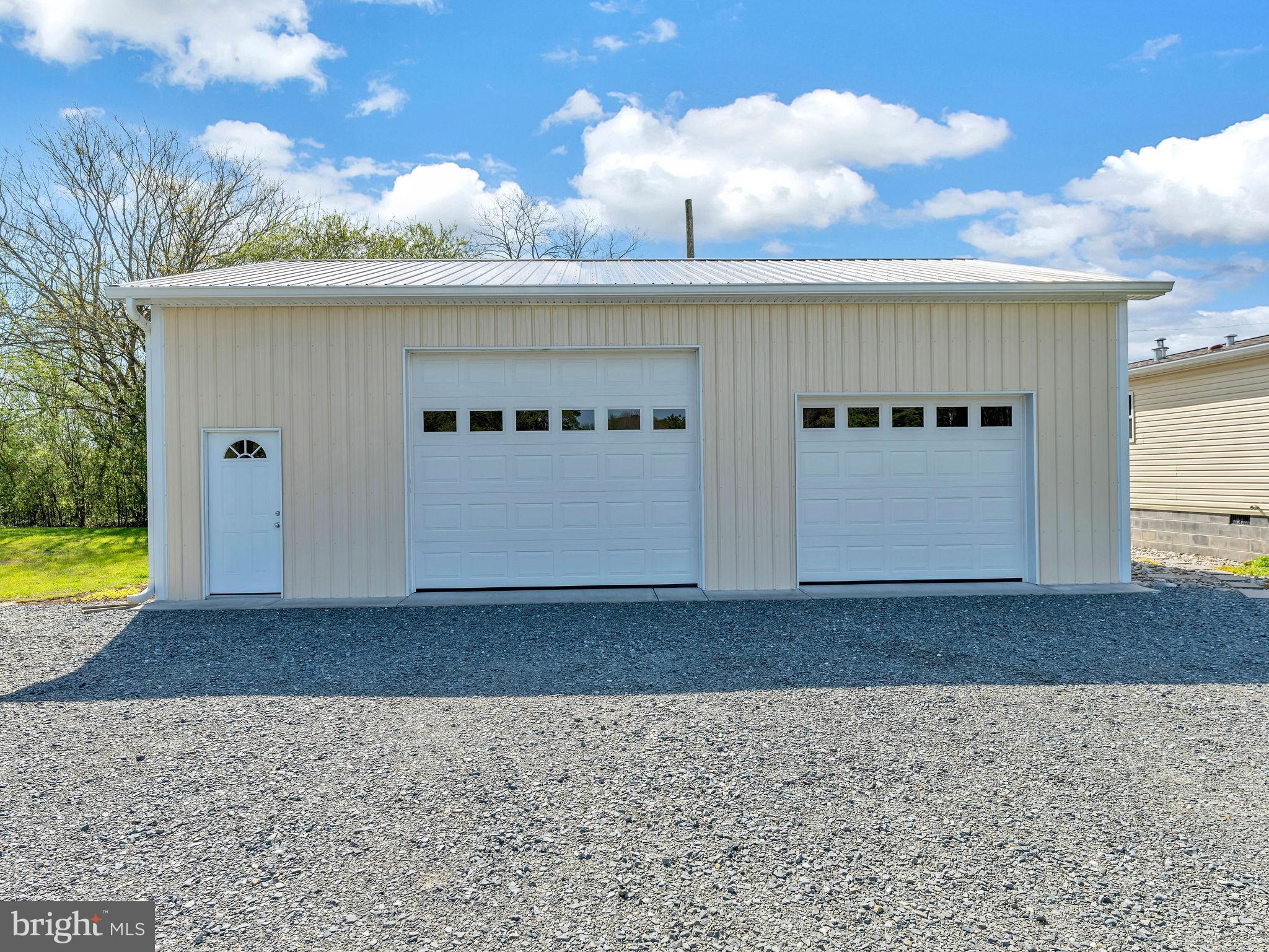 9811 Peerless Road Bishopville, MD 21813 - Photo 43 of 66 a front view of a house with a yard and garage