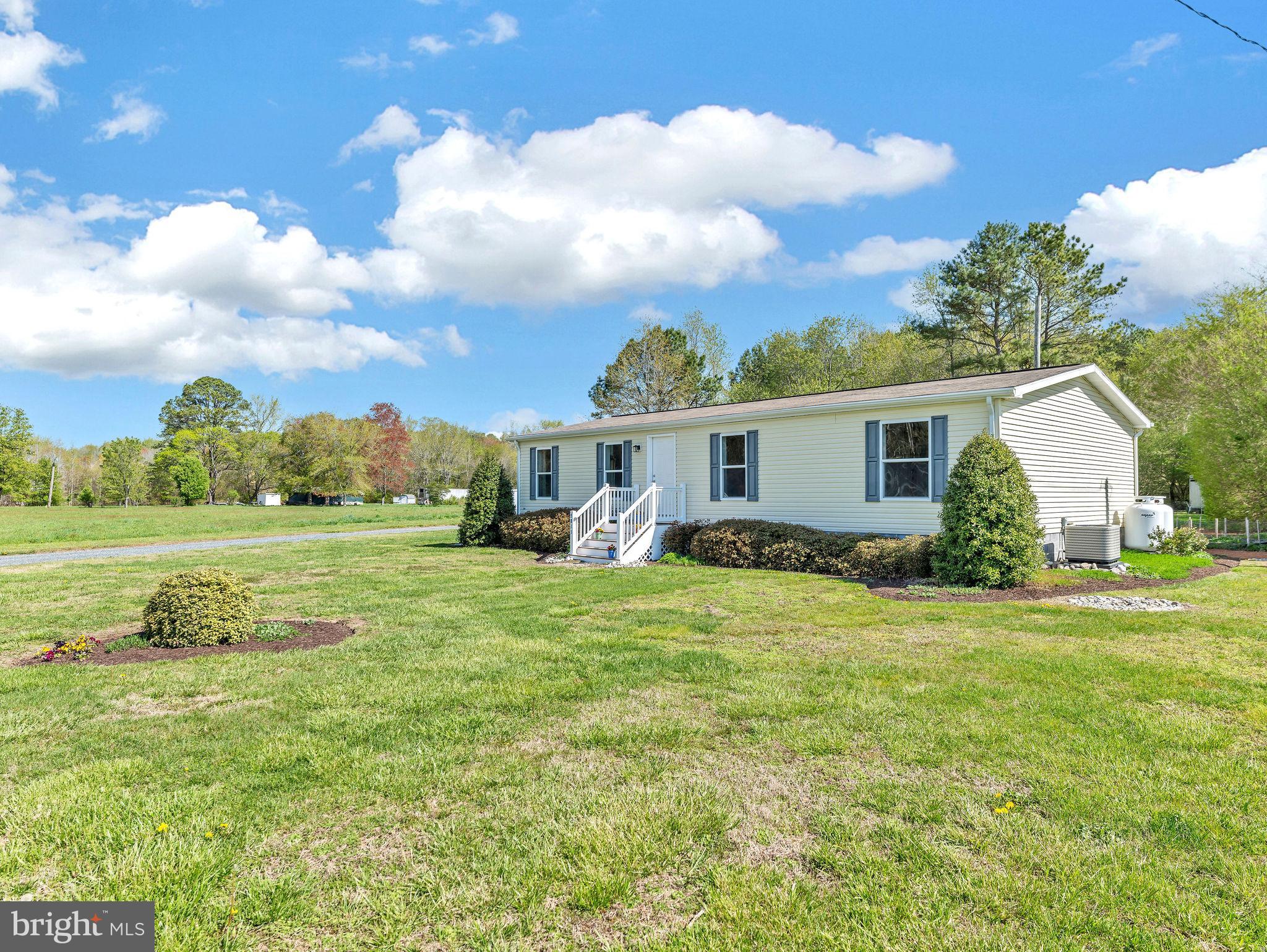 9811 Peerless Road Bishopville, MD 21813 - Photo 46 of 66 a view of a house with a yard and a patio