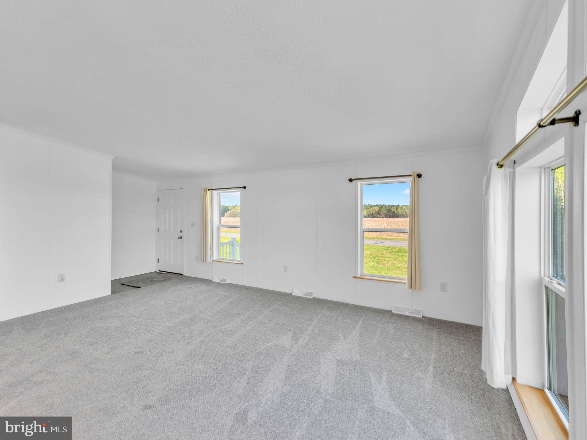 9811 Peerless Road Bishopville, MD 21813 - Photo 6 of 66 an empty room with windows