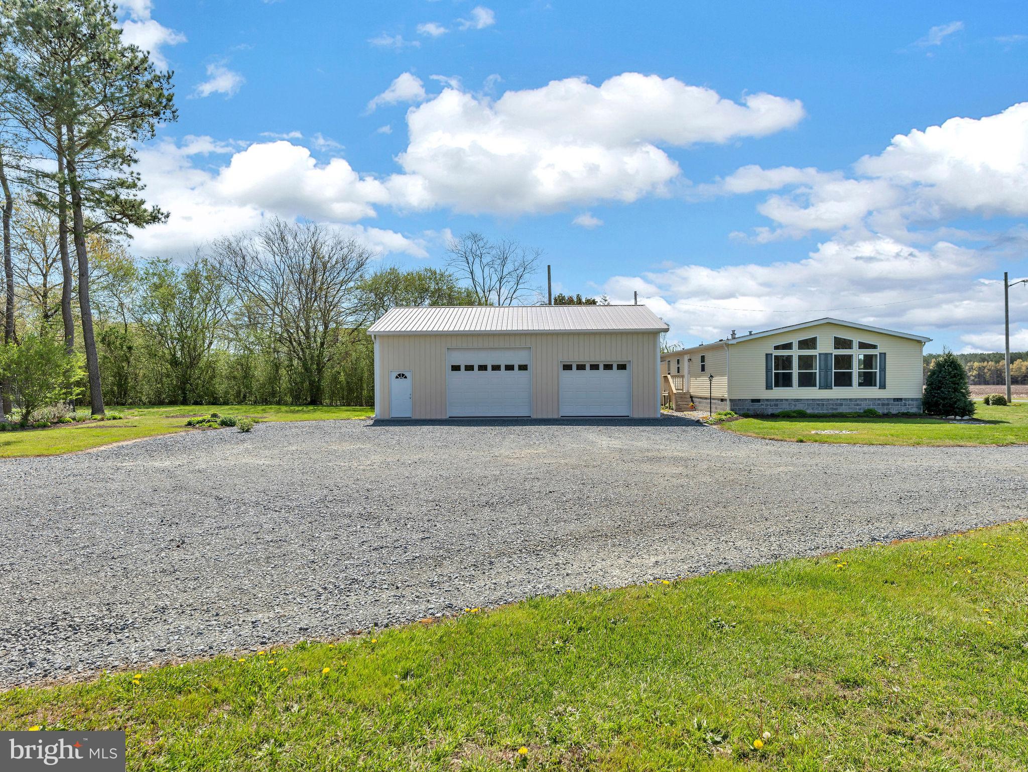 9811 Peerless Road Bishopville, MD 21813 - Photo 64 of 66 a view of a big yard with swimming pool and trees in the background