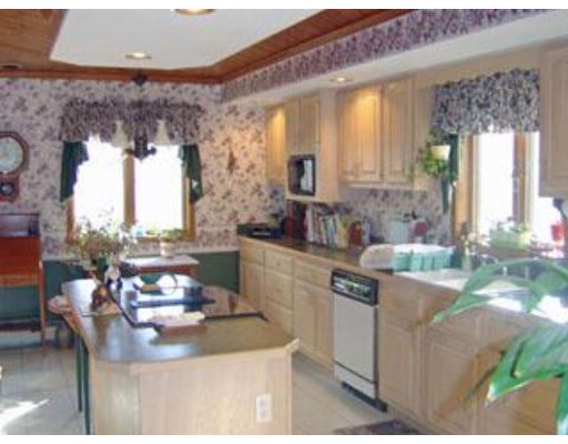 419 River Road Barnstable, MA 02648 - Photo 3 of 10 a kitchen with a stove a sink and a dining table