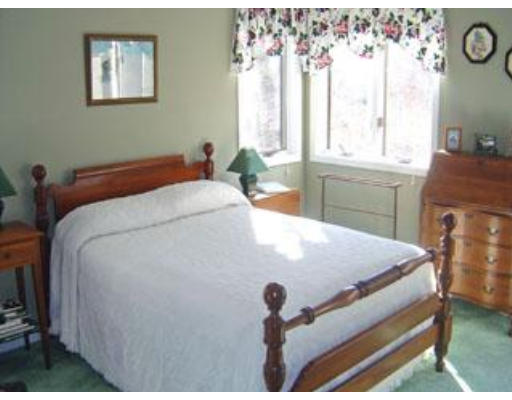 419 River Road Barnstable, MA 02648 - Photo 8 of 10 a bed sitting in a bedroom next to a window