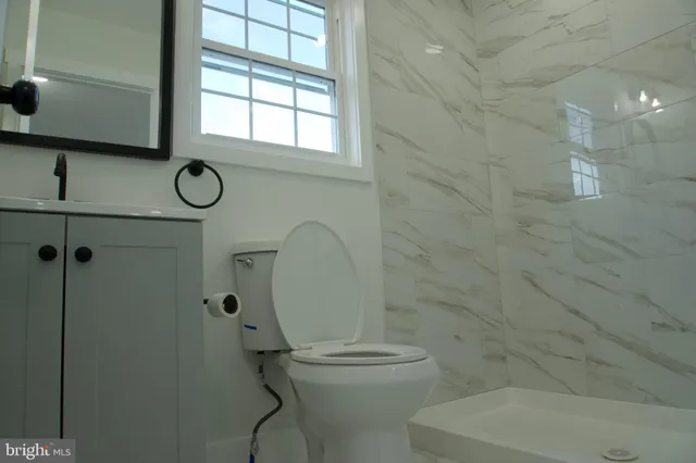 a bathroom with a toilet and a shower