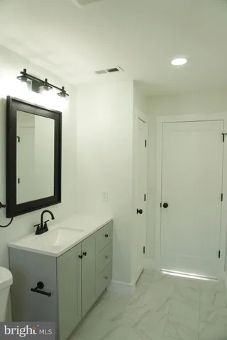 a bathroom with a double vanity sink mirror and shower