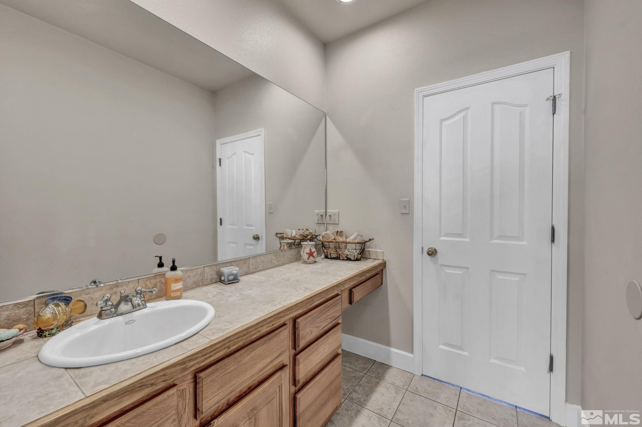 5650 South Allen Road Fallon, NV 89406 - Photo 16 of 40 a bathroom with a sink double vanity and a mirror