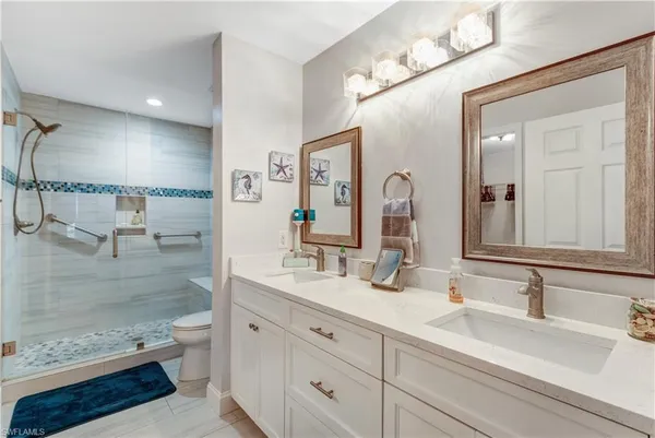 a bathroom with a double vanity sink and a mirror