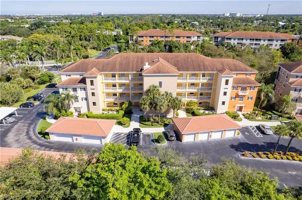 an aerial view of multiple houses with a yard