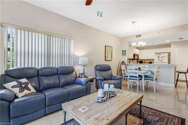a living room with furniture kitchen view and a table