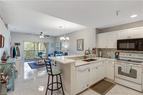 a kitchen with a sink stove and cabinets