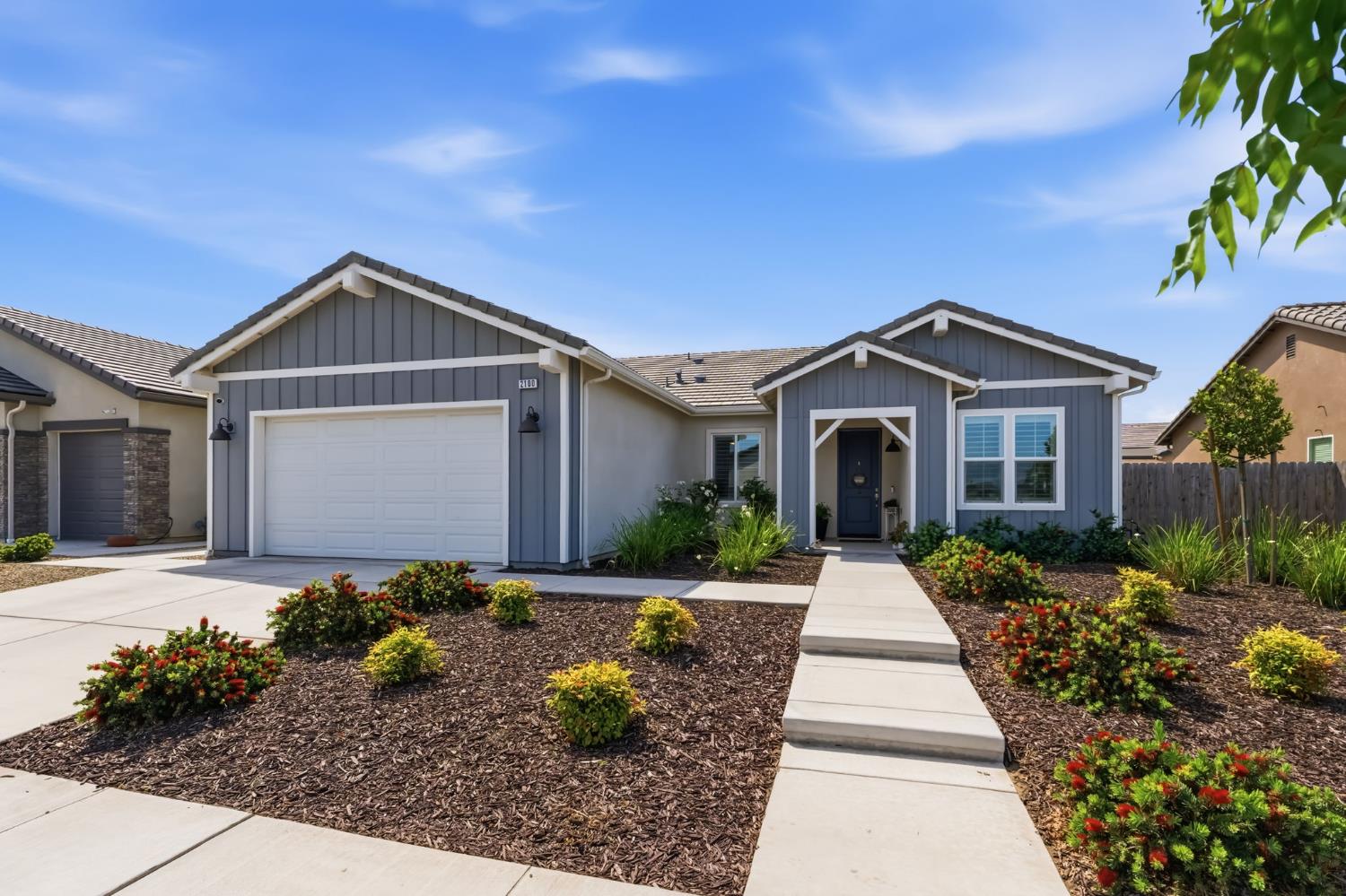 2100 Azalea Street Kingsburg, CA 93631 - Photo 1 of 54 a front view of a house with garden