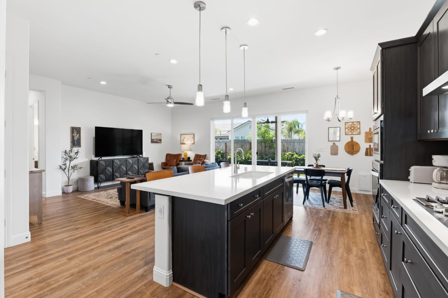 2100 Azalea Street Kingsburg, CA 93631 - Photo 12 of 54 a kitchen with a stove and a wooden floor